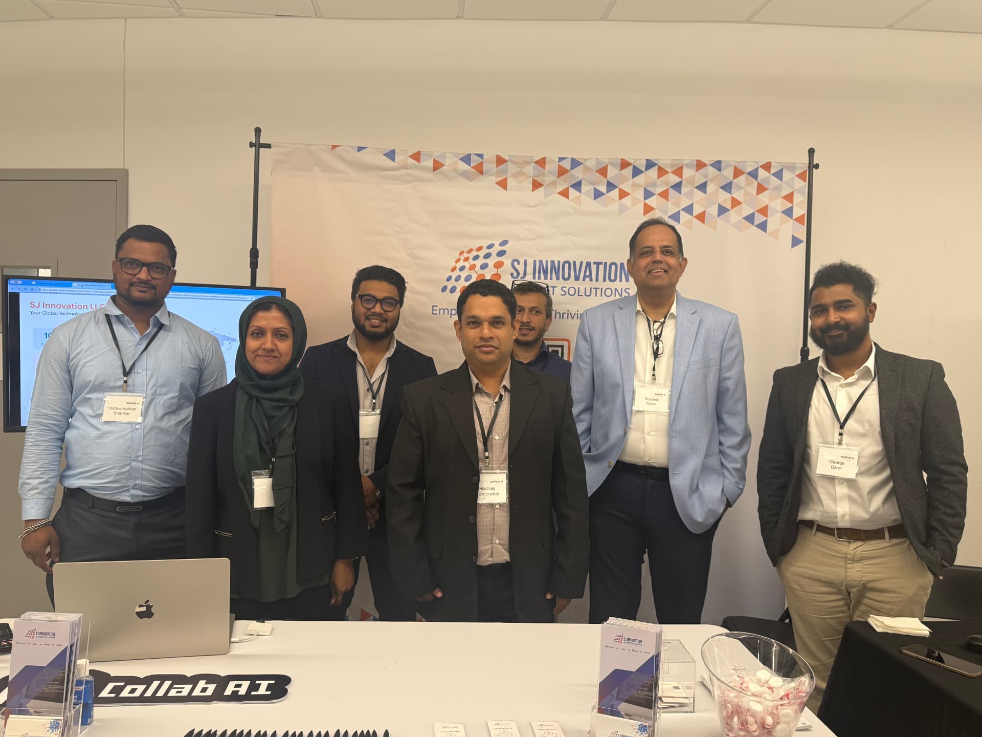 The SJ Innovation team at a Queens AI event table